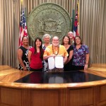 Gov. Neil Abercrombie with some of the adult supporters of Senate Bill 1340
